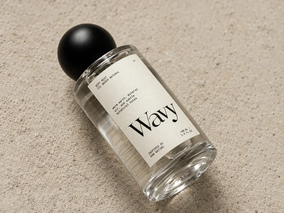 Wavy body mist bottle with a custom printed label